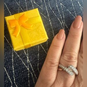 Rose gold with swirled micro pave set clear gemstones. Size 10 ring.